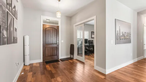 a view of entryway with kitchen and livingroom
