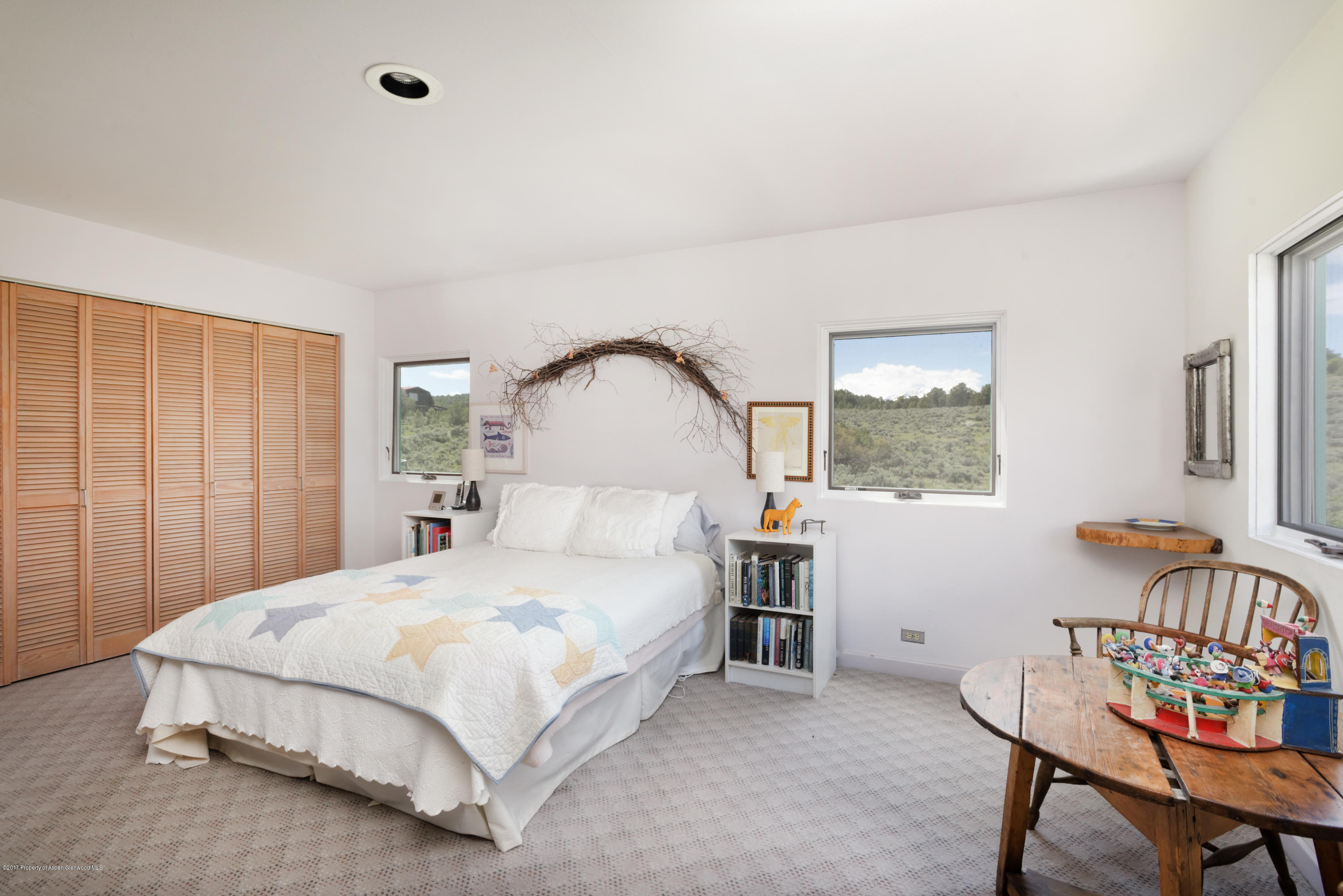 525 Cactus Flats Road Carbondale, CO 81623 - Photo 12 of 49 a bedroom with a bed and a table in it
