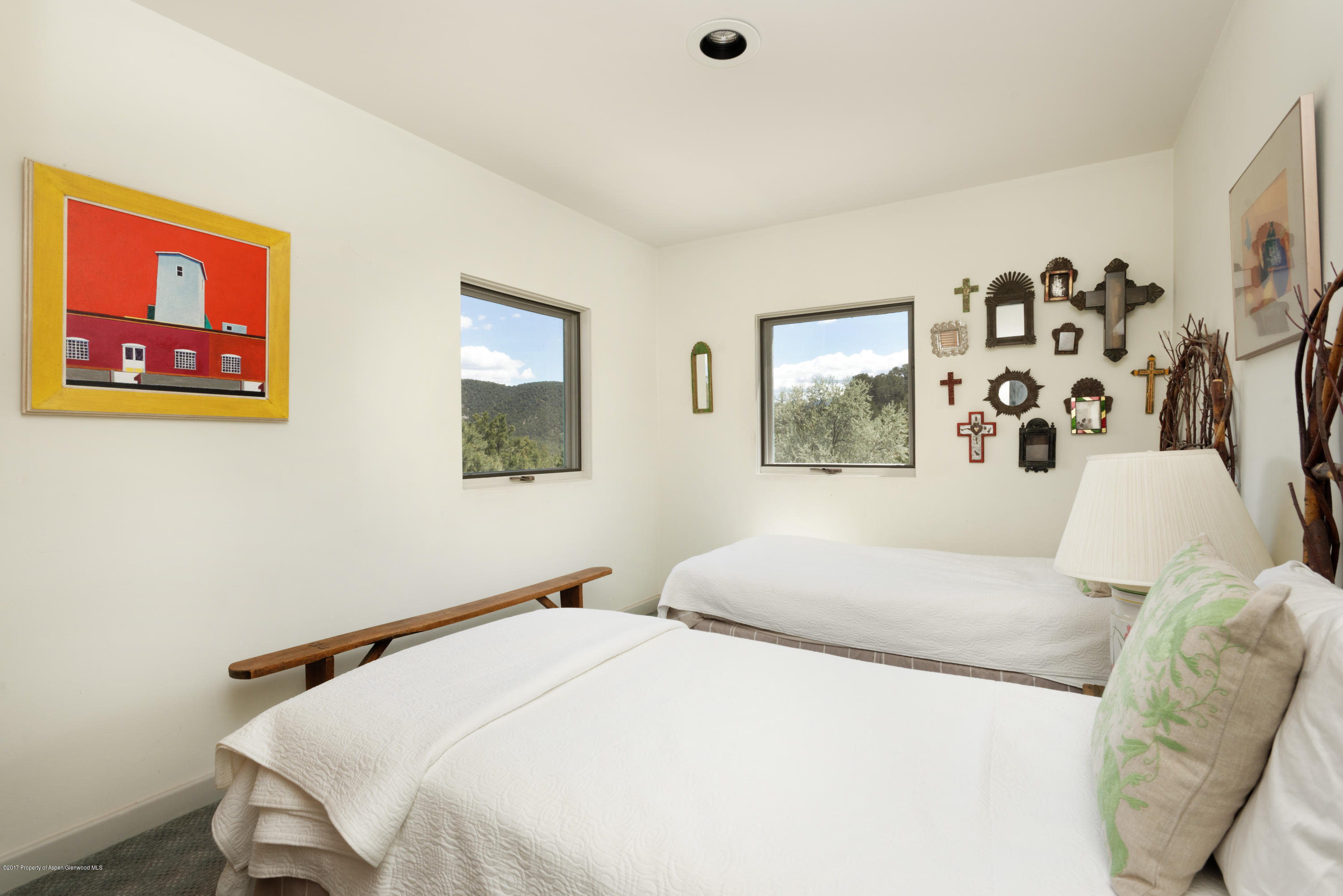525 Cactus Flats Road Carbondale, CO 81623 - Photo 15 of 49 a bedroom with a bed and wall painting with wooden floor