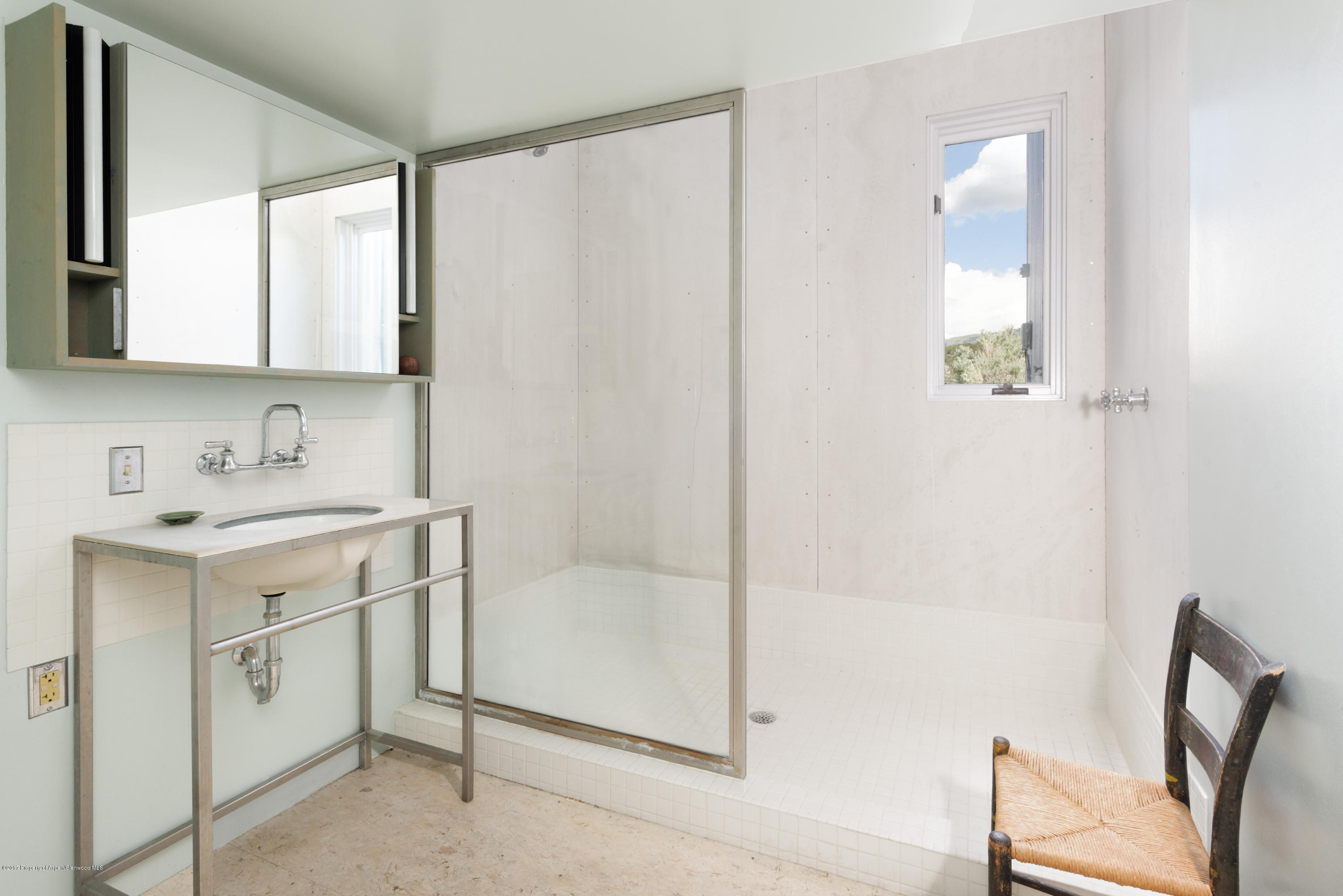 525 Cactus Flats Road Carbondale, CO 81623 - Photo 20 of 49 a bathroom with a granite countertop sink a mirror and a shower