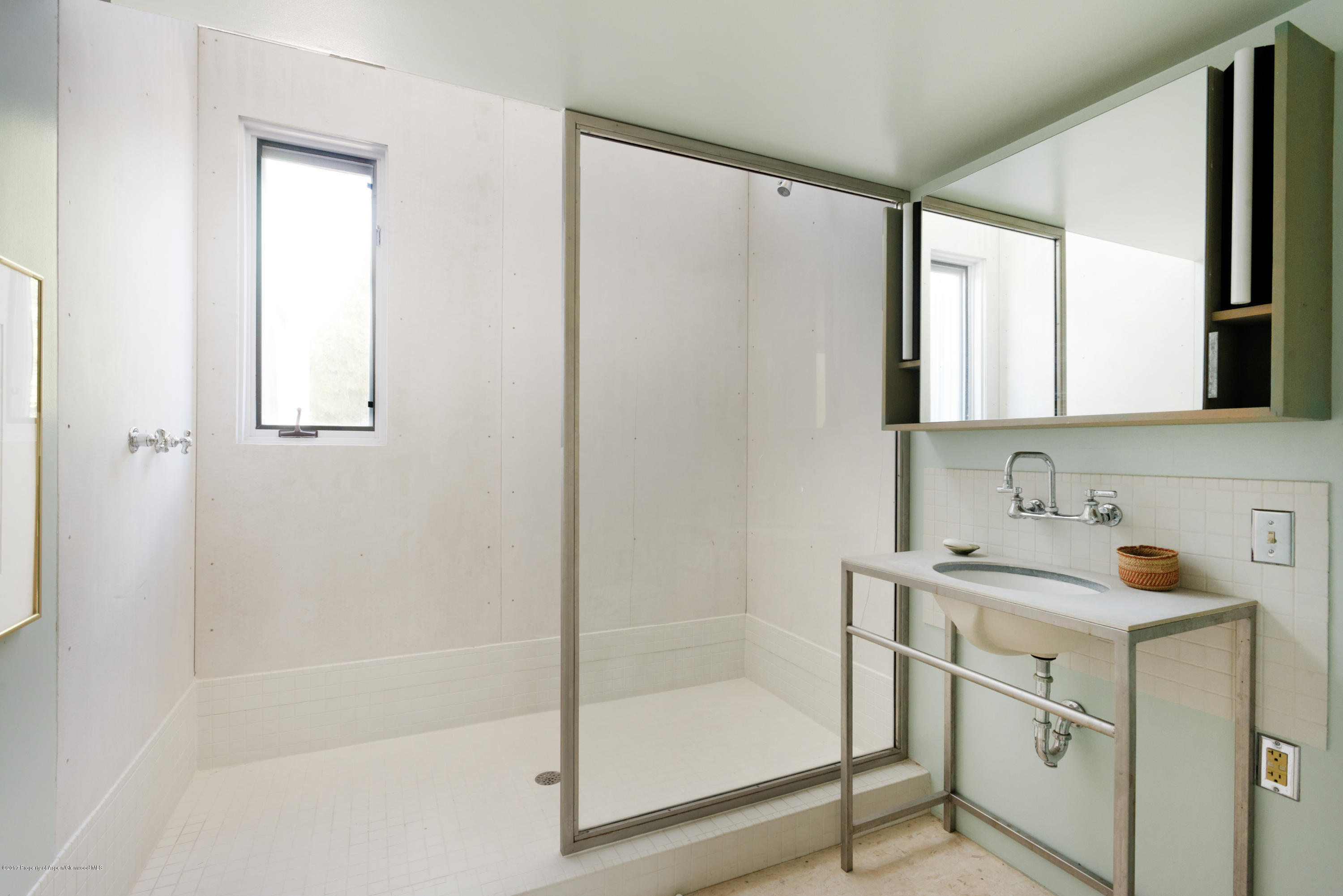 525 Cactus Flats Road Carbondale, CO 81623 - Photo 23 of 49 a bathroom with a bathtub a mirror a sink and a shower