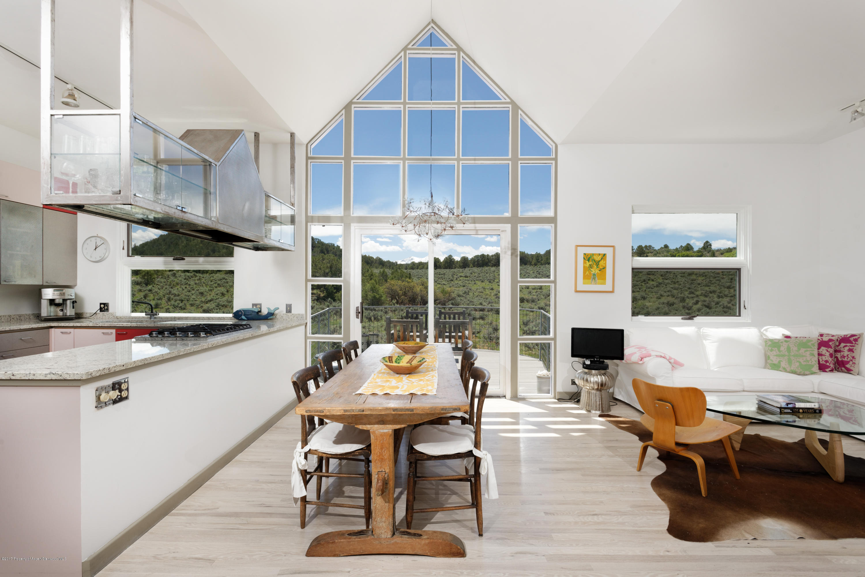 525 Cactus Flats Road Carbondale, CO 81623 - Photo 4 of 49 a kitchen with a sink dining table and chairs