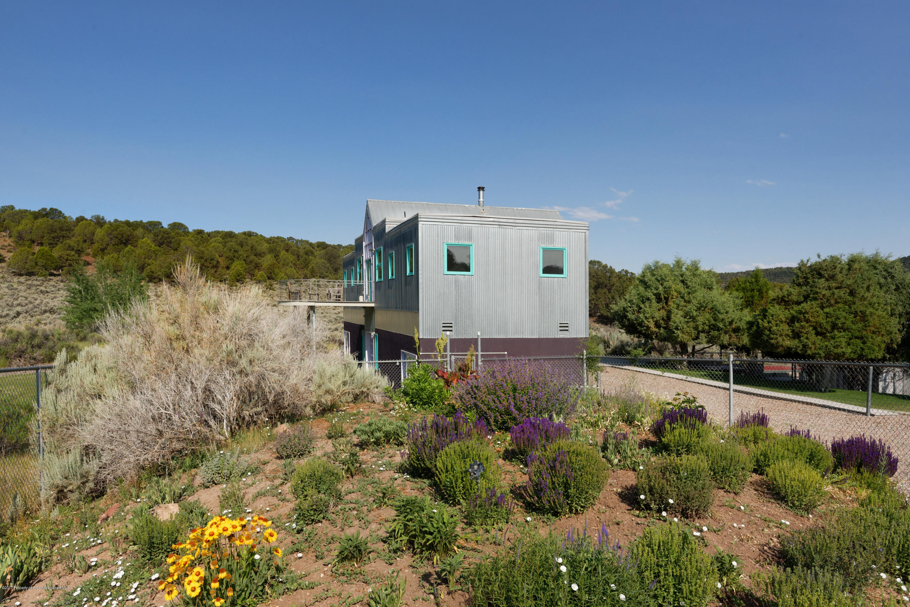 525 Cactus Flats Road Carbondale, CO 81623 - Photo 48 of 49 a view of a house with a yard and potted plants
