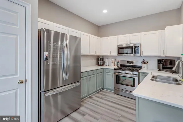 a kitchen with a refrigerator stove and microwave