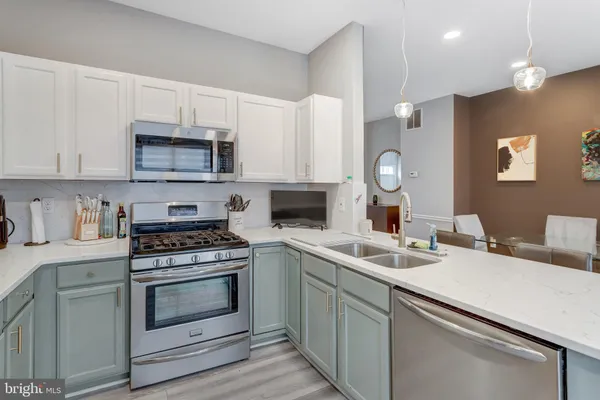 a kitchen with a sink stove and microwave
