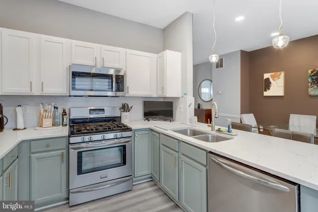 a kitchen with a sink stove and microwave