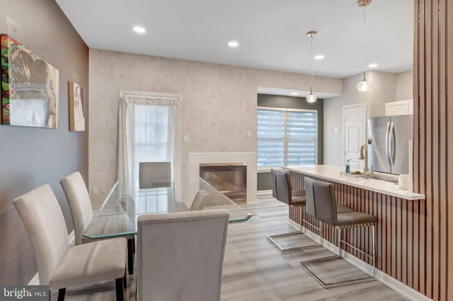 a living room with furniture a fireplace and a large window