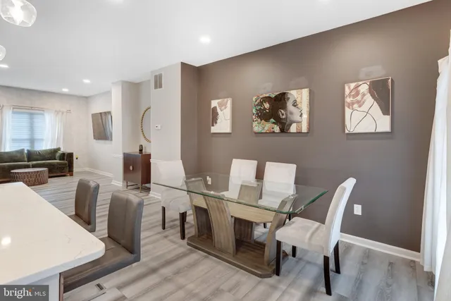 a view of a workspace with furniture and wooden floor