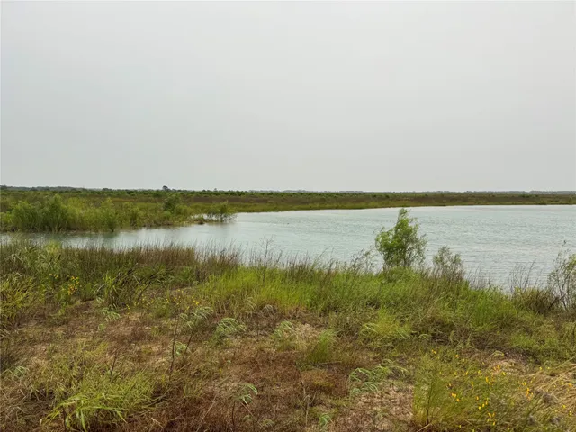 a view of a lake with houses in the back