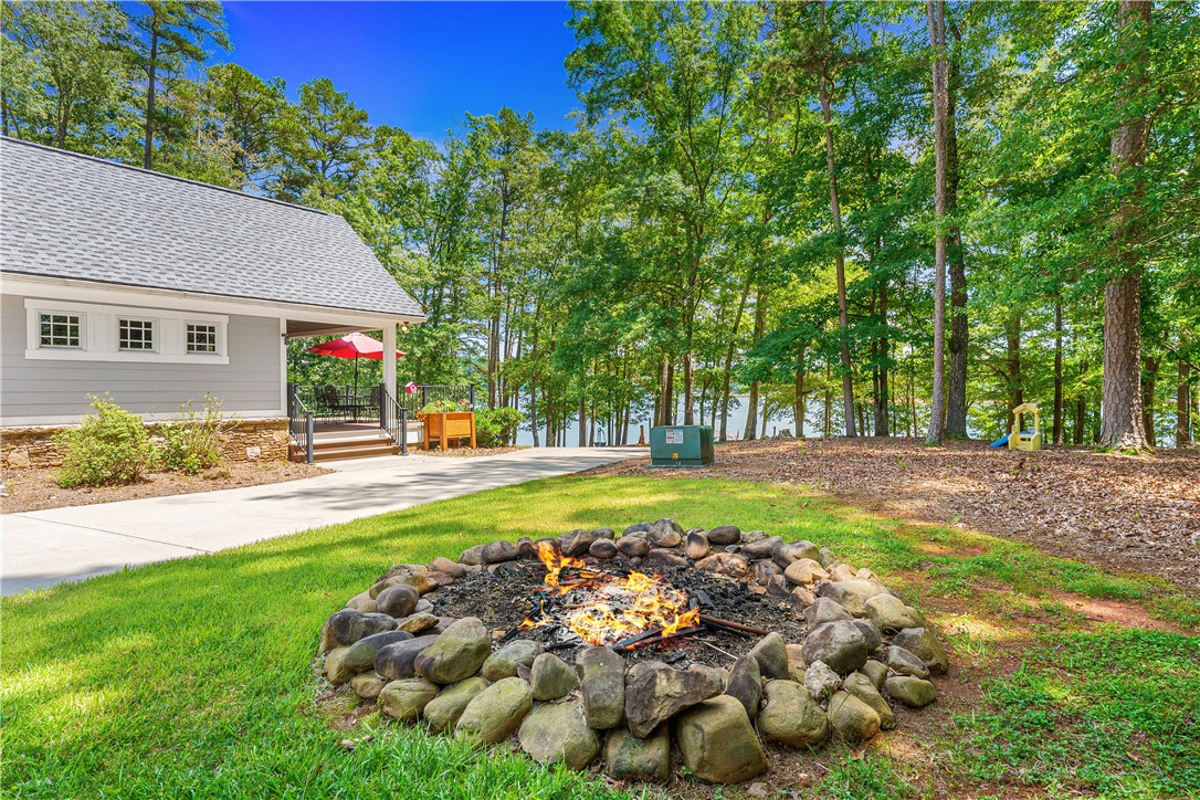 285 Bertha Allen Road Westminster, SC 29693 - Photo 33 of 50 Gather around the fire pit for cozy evenings with a water view and forested backdrop.