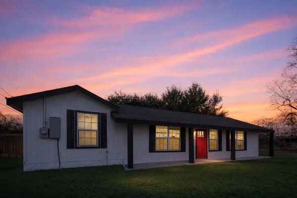 a view of house with yard and entertaining space
