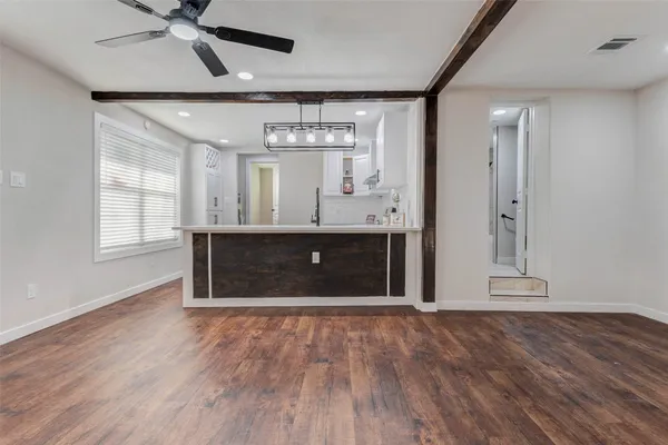 a view of kitchen with granite countertop cabinets and wooden floor