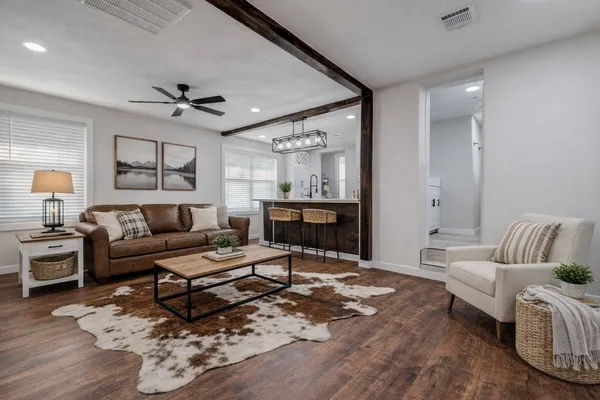 a living room with furniture a rug and a chandelier