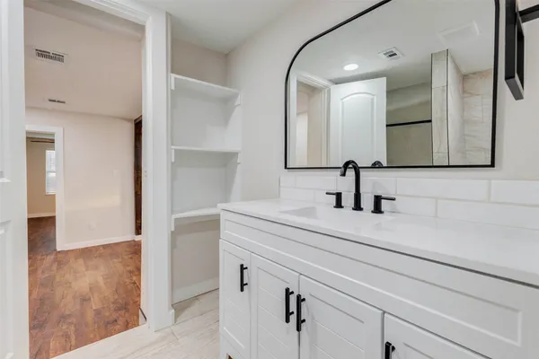 a bathroom with a sink and a mirror