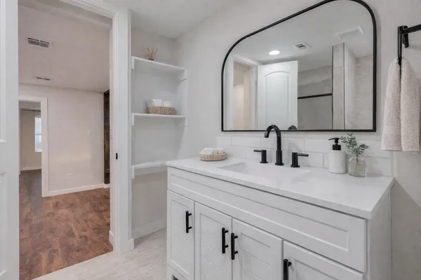 a bathroom with a sink and a mirror