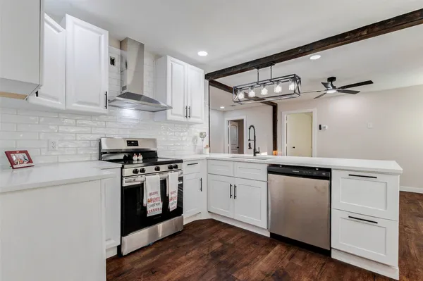 a kitchen with stainless steel appliances granite countertop a sink and cabinets