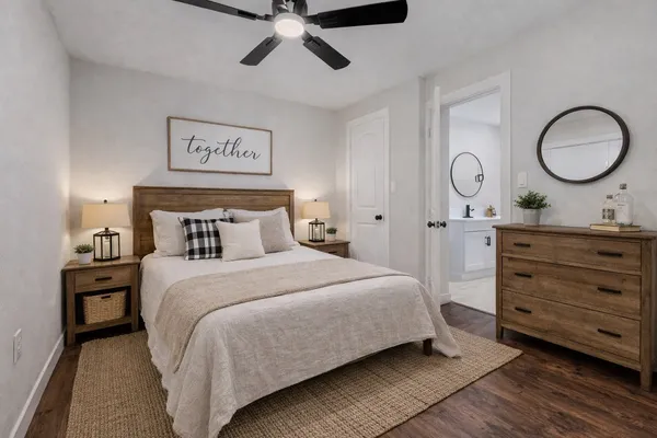 a bedroom with a bed and a mirror