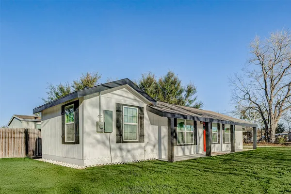 a front view of house with a garden