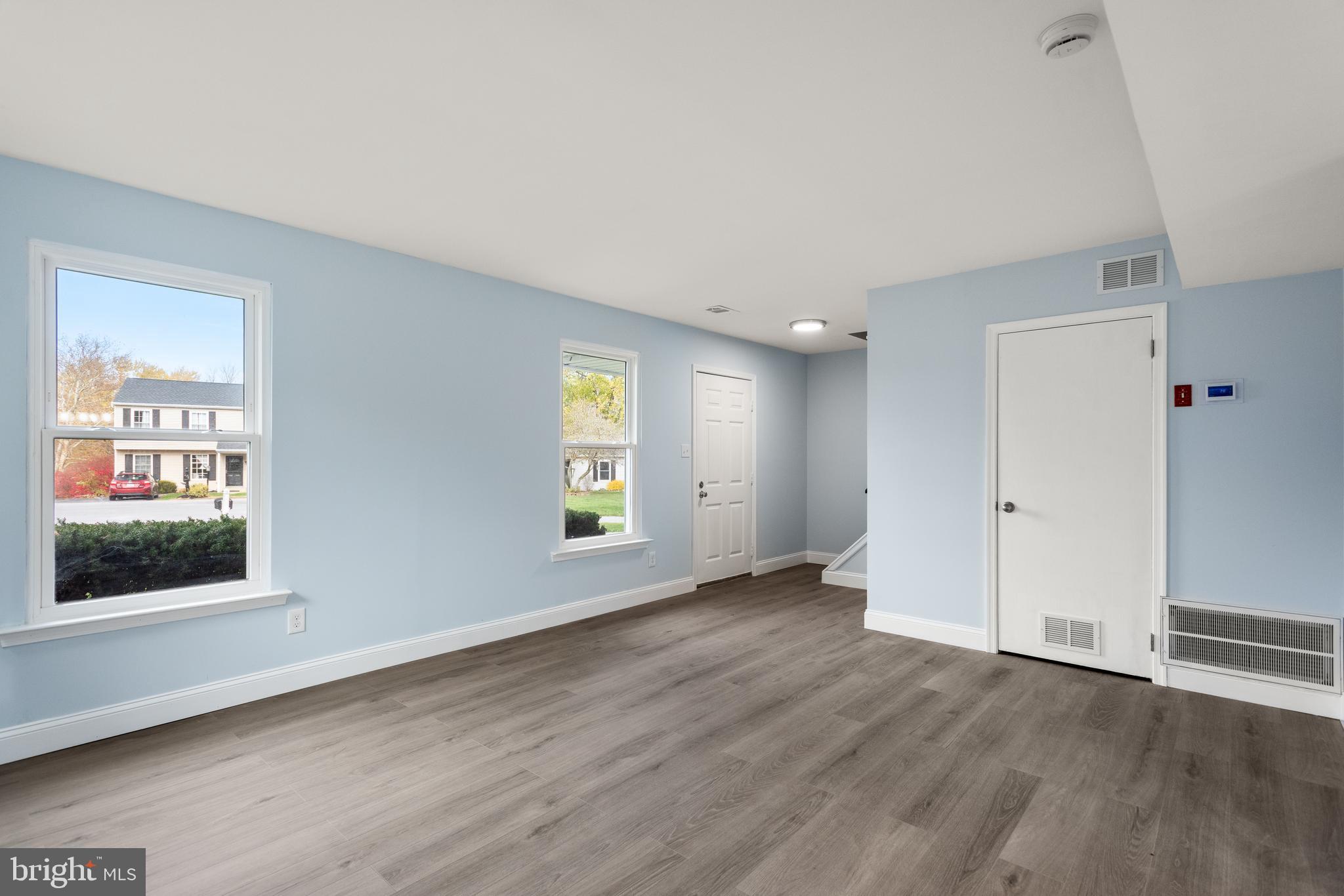 19 Windemere Court Downingtown, PA 19335 - Photo 3 of 24 an empty room with wooden floor and windows