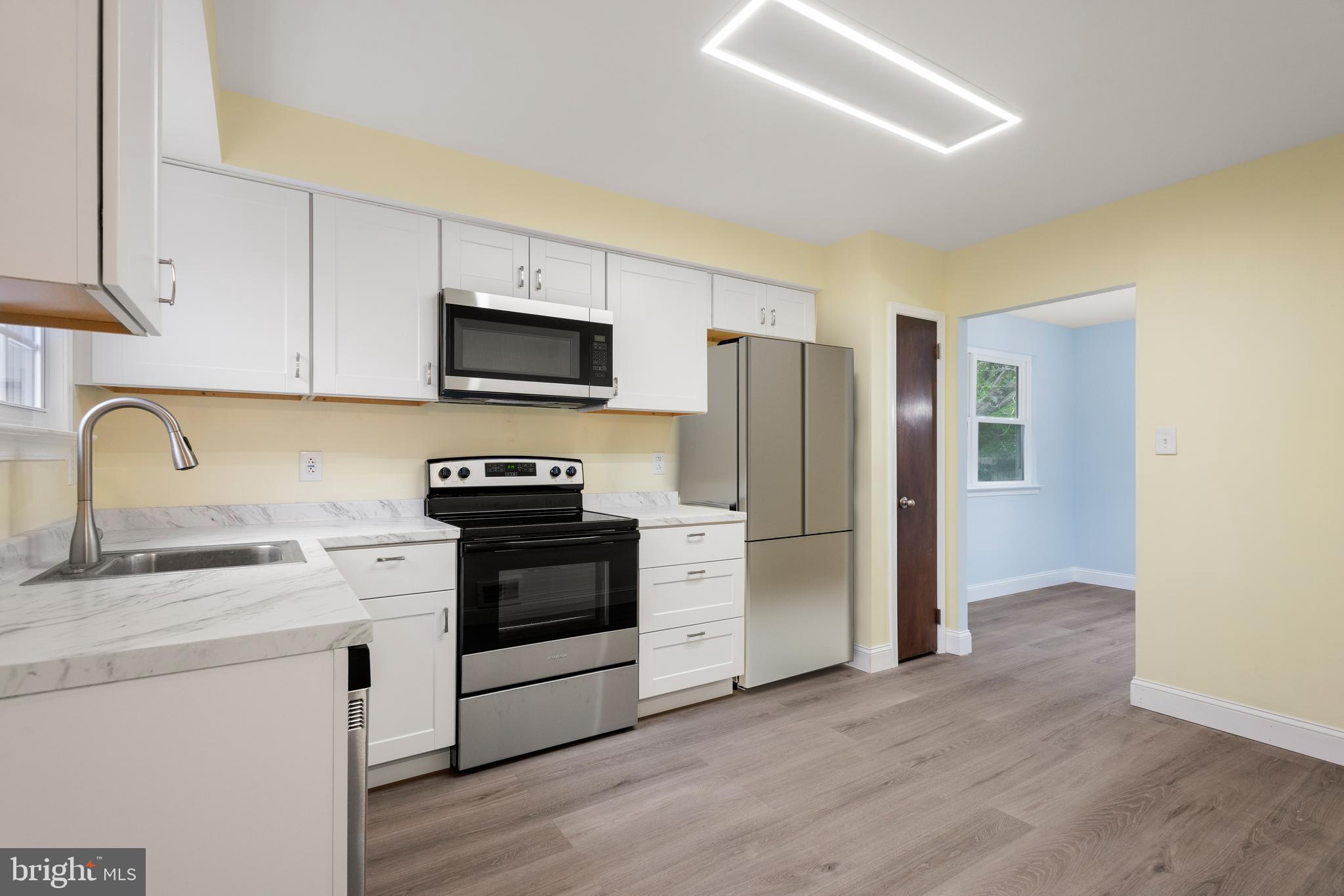 19 Windemere Court Downingtown, PA 19335 - Photo 10 of 24 a kitchen with stainless steel appliances a stove microwave and a sink