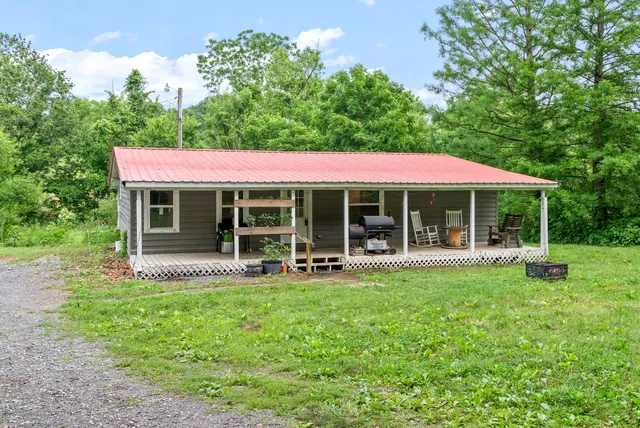 a front view of a house with garden and porch