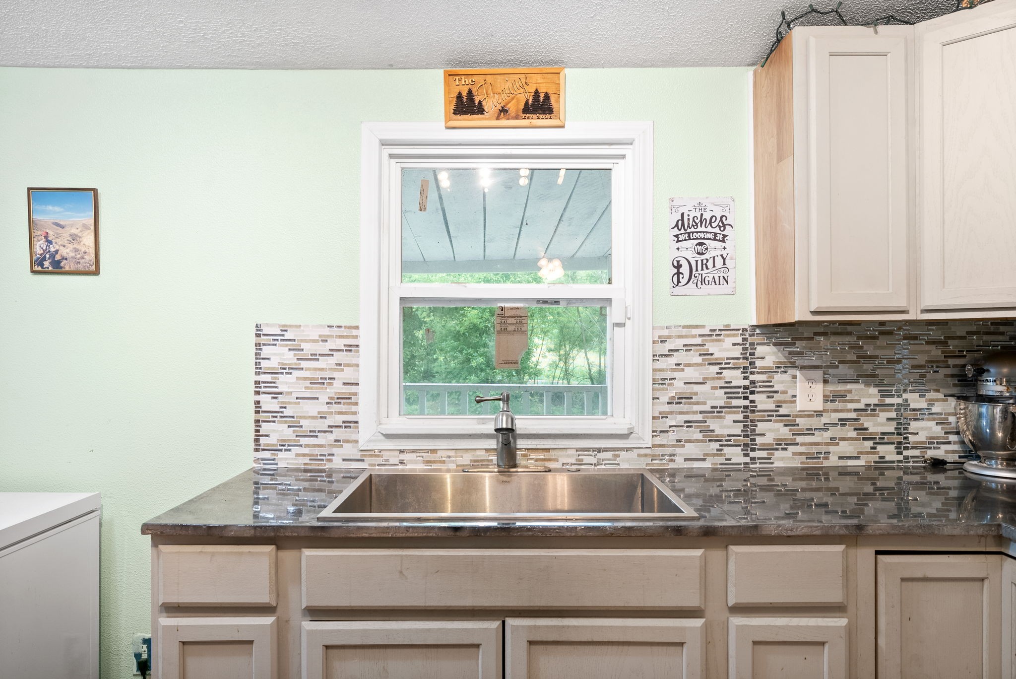 110 Little Fork Road Cumberland City, TN 37050 - Photo 13 of 32 a kitchen with granite countertop a sink and a window