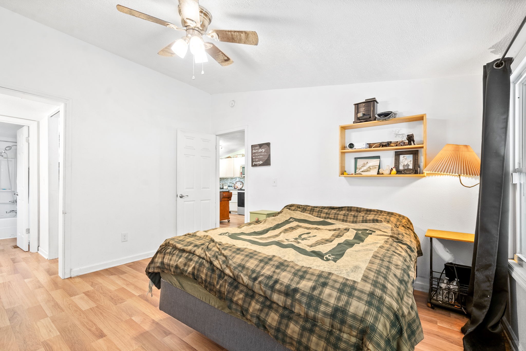 110 Little Fork Road Cumberland City, TN 37050 - Photo 15 of 32 a bedroom with a bed and a chandelier
