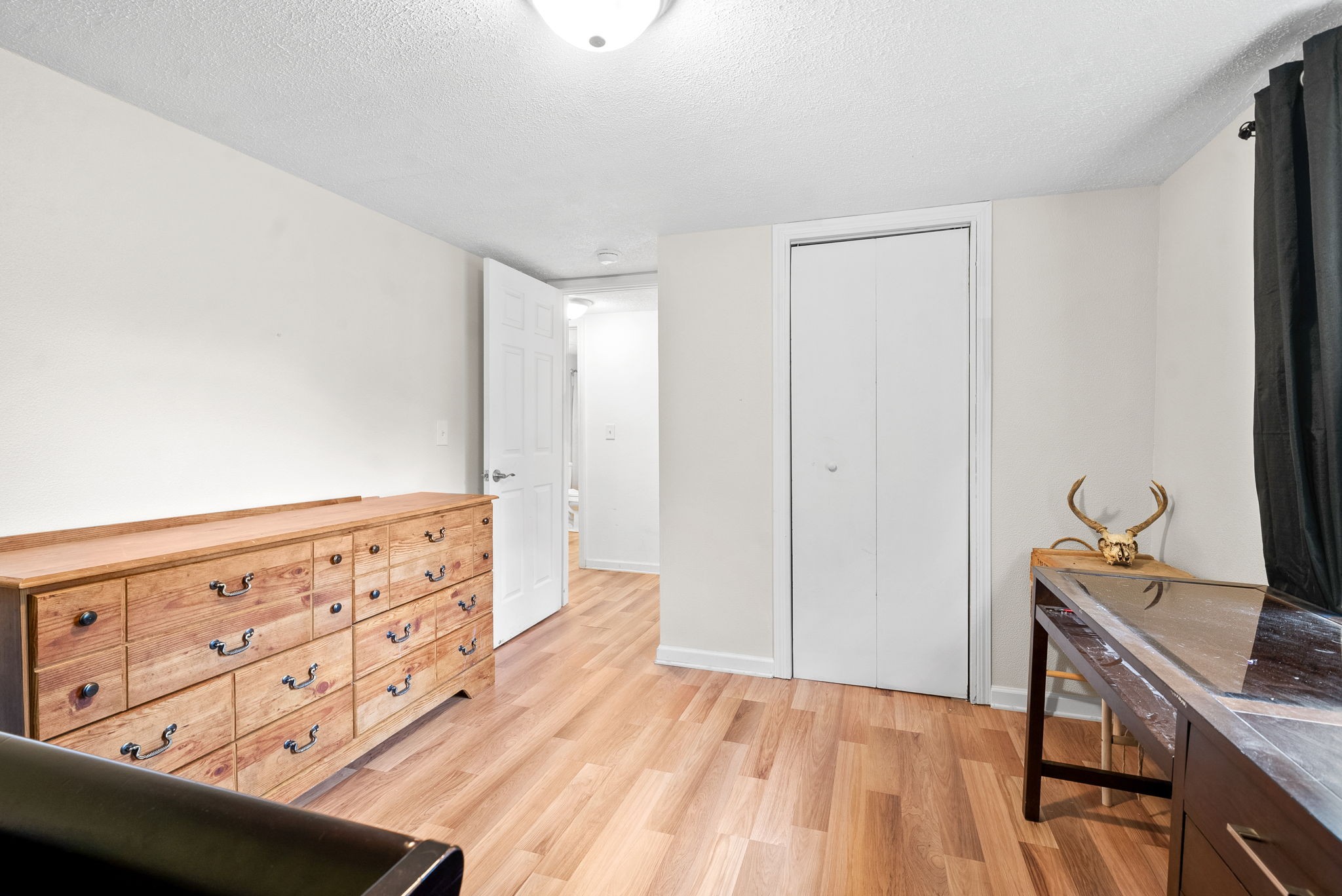 110 Little Fork Road Cumberland City, TN 37050 - Photo 19 of 32 a view of a room with wooden floor and cabinet