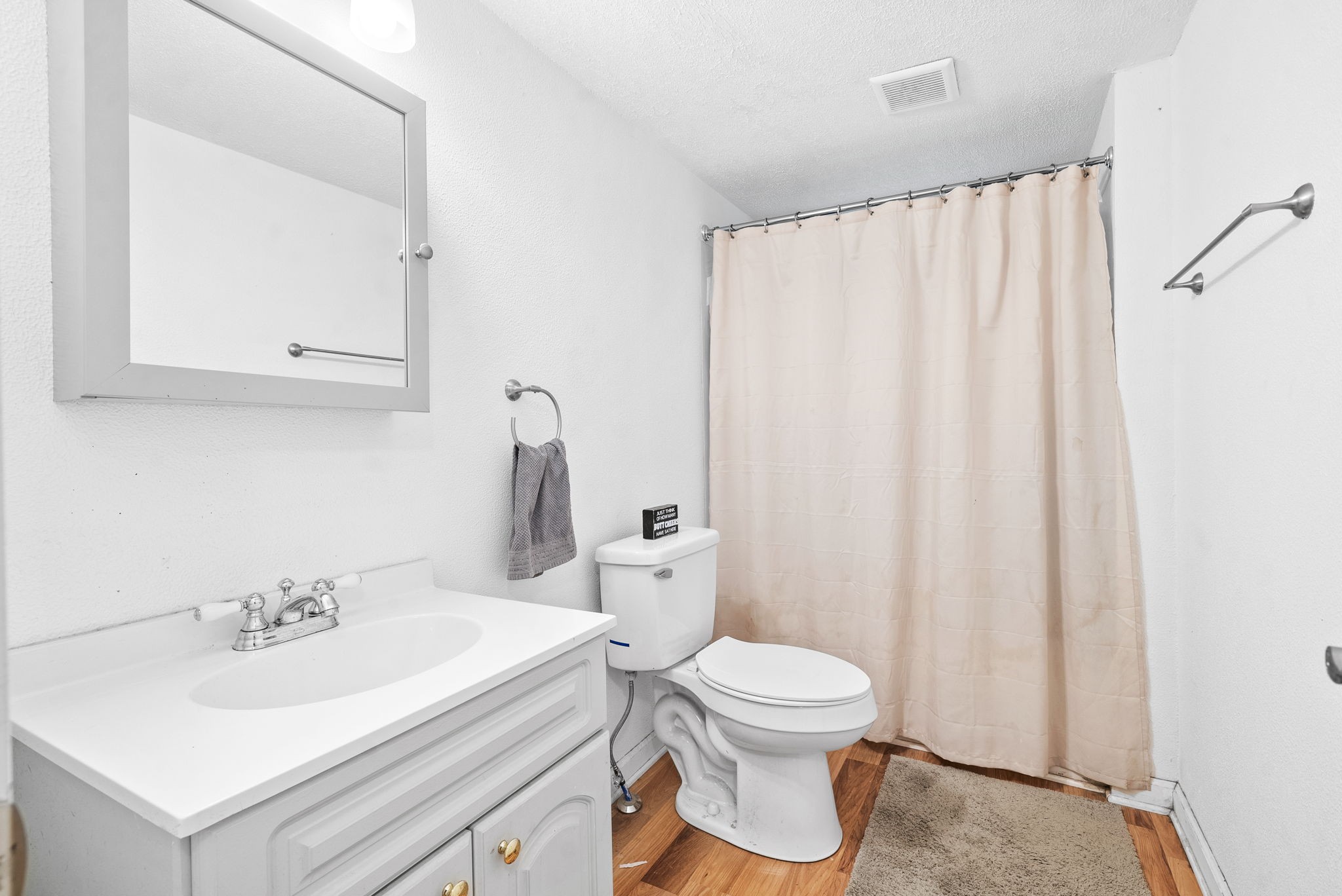 110 Little Fork Road Cumberland City, TN 37050 - Photo 20 of 32 a white toilet sitting next to a bathroom sink