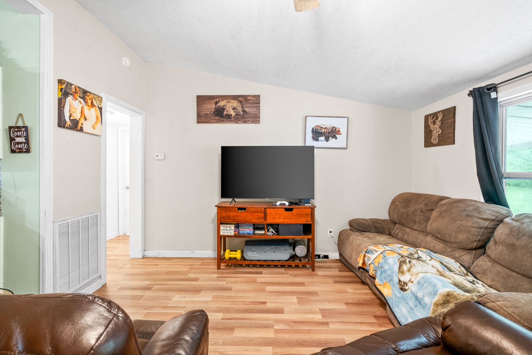 110 Little Fork Road Cumberland City, TN 37050 - Photo 8 of 32 a living room with furniture and a flat screen tv