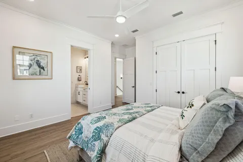 a bedroom with a bed and a painting on the wall