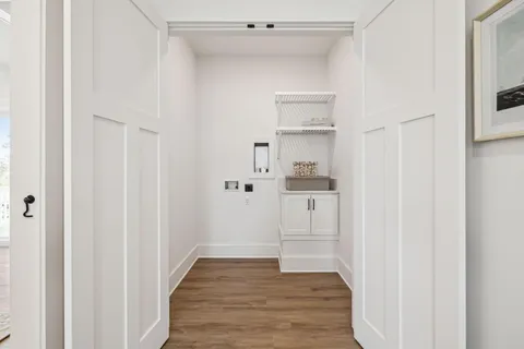 a view of a hallway with wooden floor