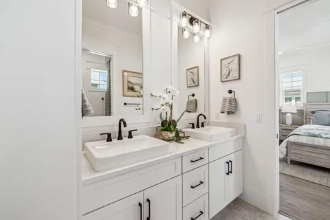 a bathroom with double sink and a mirror