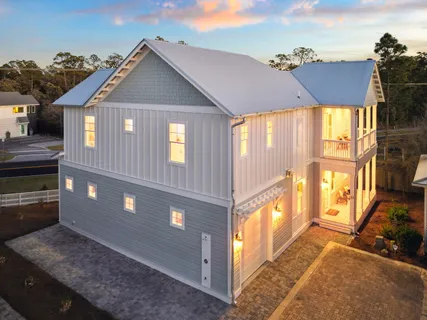 a view of a house with a floor to ceiling window and wooden floor