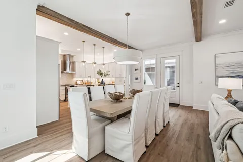 a dining room with furniture and wooden floor