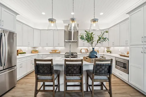 a kitchen with kitchen island granite countertop a table and chairs in it