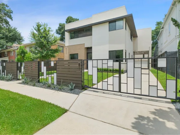 a view of a house with a backyard and a porch