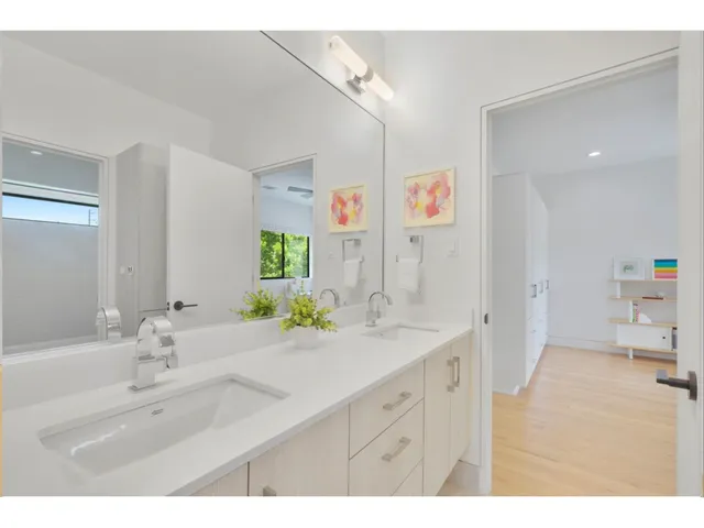 a spacious bathroom with a sink double vanity and a mirror