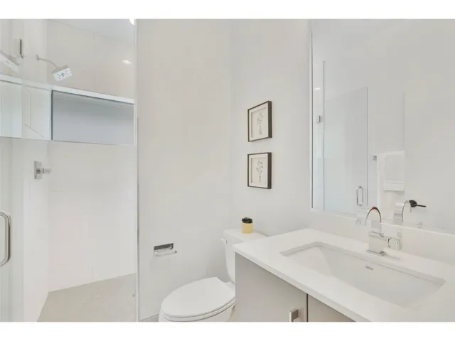 a bathroom with a sink toilet and mirror