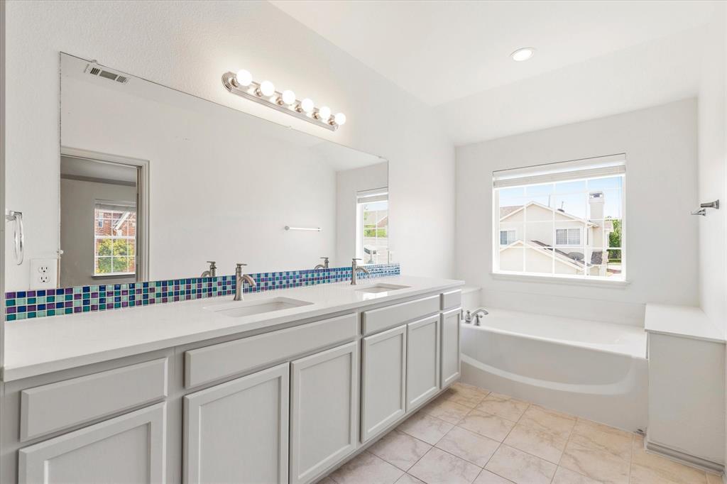 706 South Jupiter Road, Unit 1101 Allen, TX 75002 - Photo 21 of 31 a bathroom with a large tub sink and mirror