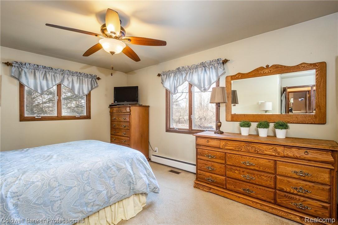 4777 Six Mile Road South Lyon, MI 48178 - Photo 38 of 71 Master bedroom plenty of natural light and a view of the paddock