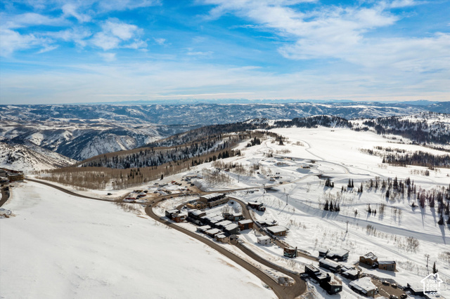 8456 Copper Crest Road, Unit 148 Eden, UT 84310 - Photo 10 of 34 Mountainous terrain with expansive snow-covered landscapes, numerous properties, and paved access roads