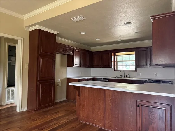 a kitchen with stainless steel appliances granite countertop a sink a stove and a refrigerator