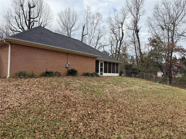 a backyard of a house with large trees
