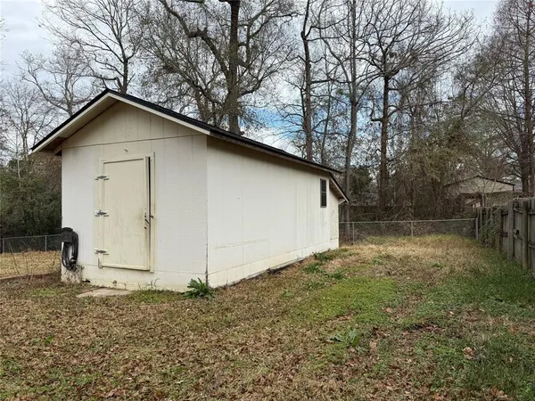 a white house that has a tree in front of it
