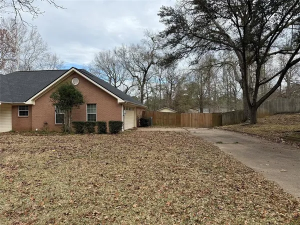 a backyard of a house with large trees