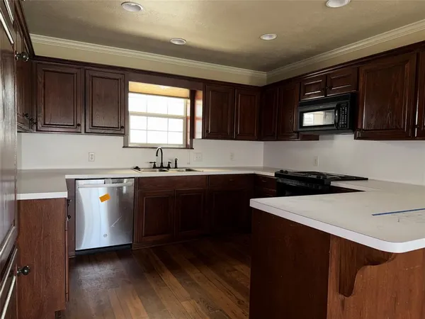 a kitchen with stainless steel appliances granite countertop a sink stove and microwave