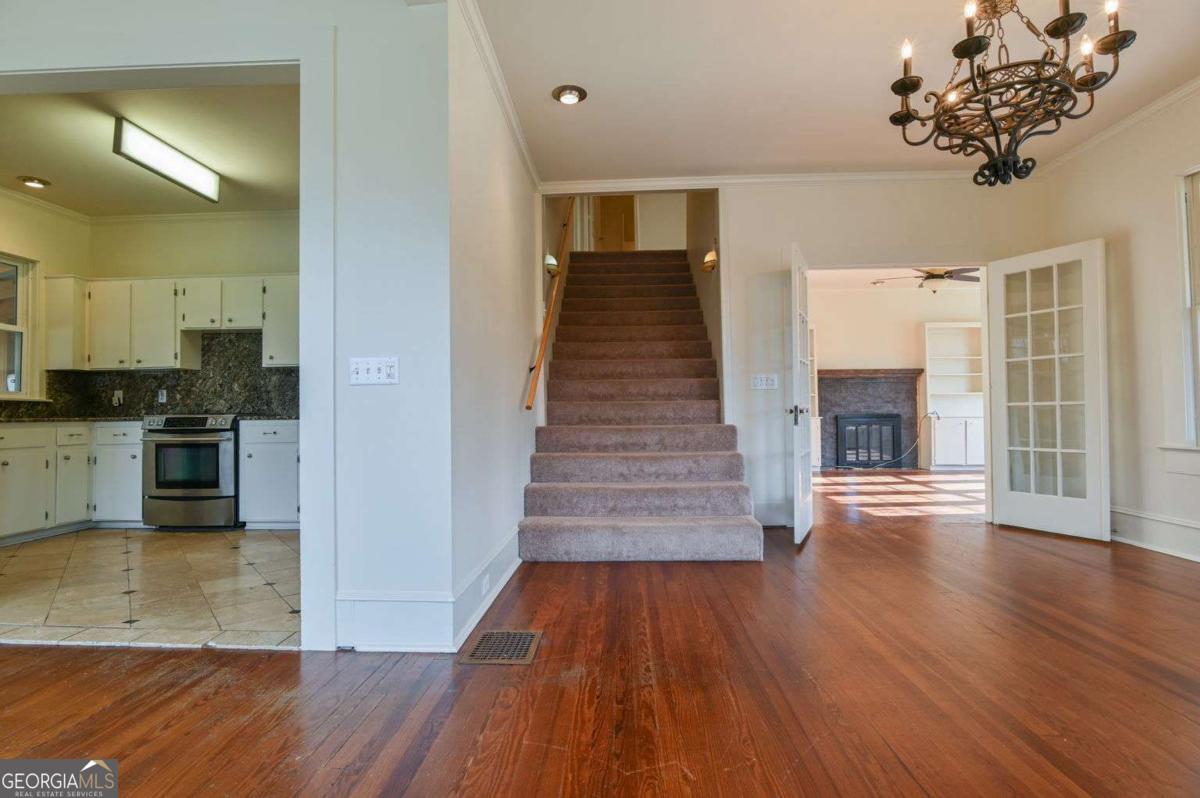 120 Tusten Street Elberton, GA 30635 - Photo 11 of 49 a view of a hallway with wooden floor and a kitchen