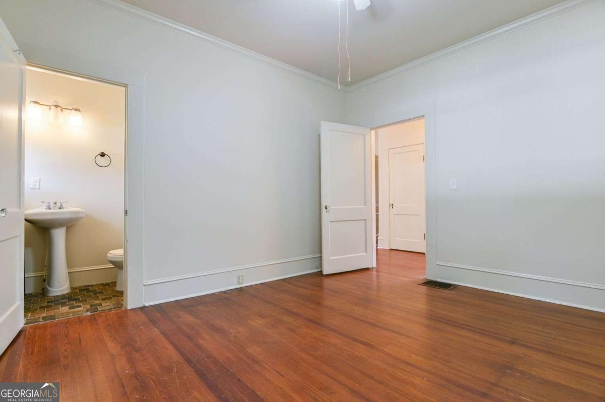 120 Tusten Street Elberton, GA 30635 - Photo 20 of 49 an empty room with wooden floor and mirror