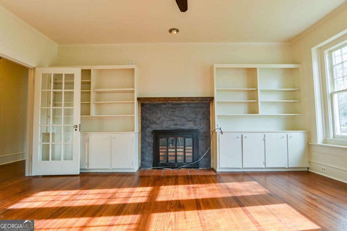 120 Tusten Street Elberton, GA 30635 - Photo 4 of 49 a view of empty room with a fireplace and window